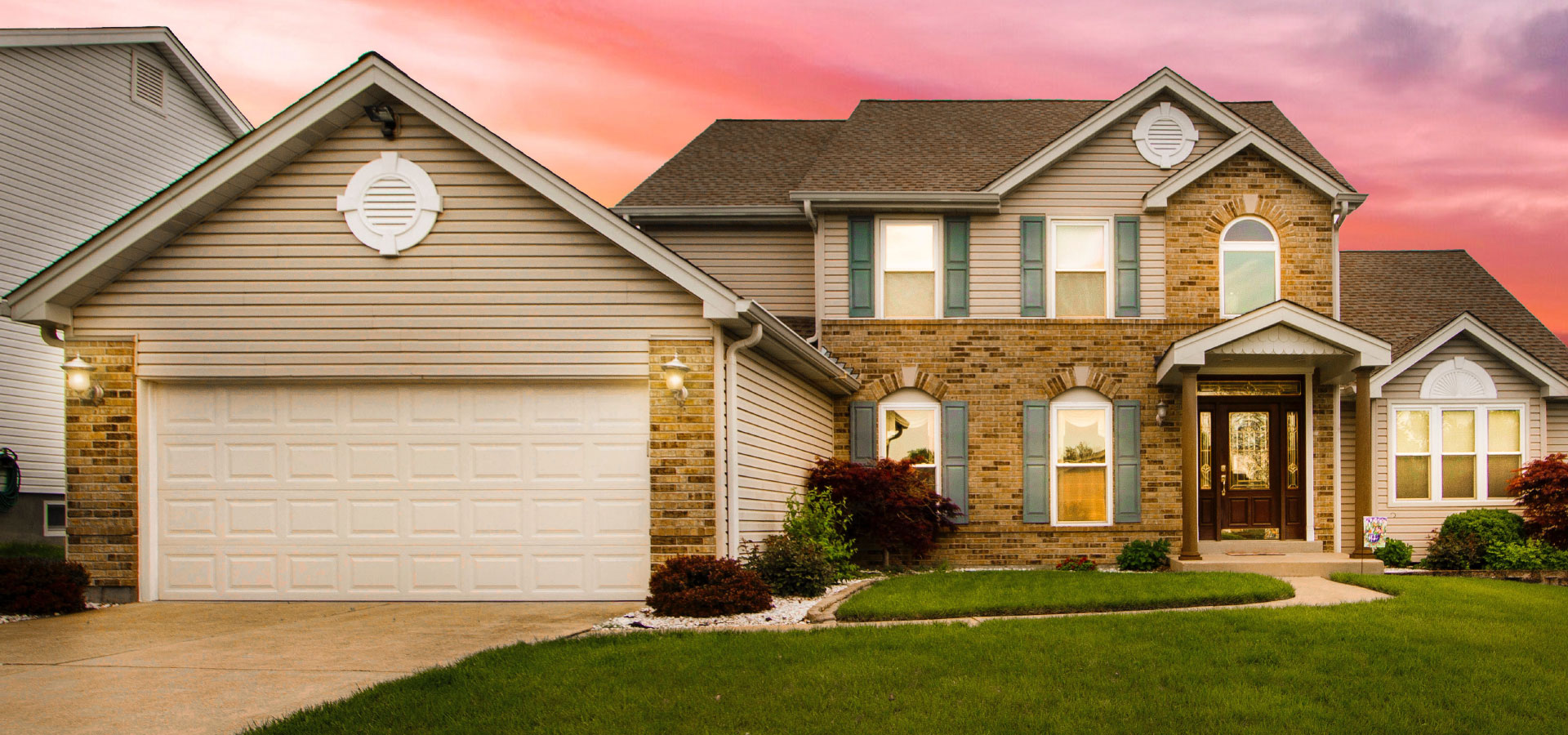Beautiful home with a Level Up garage door at dusk